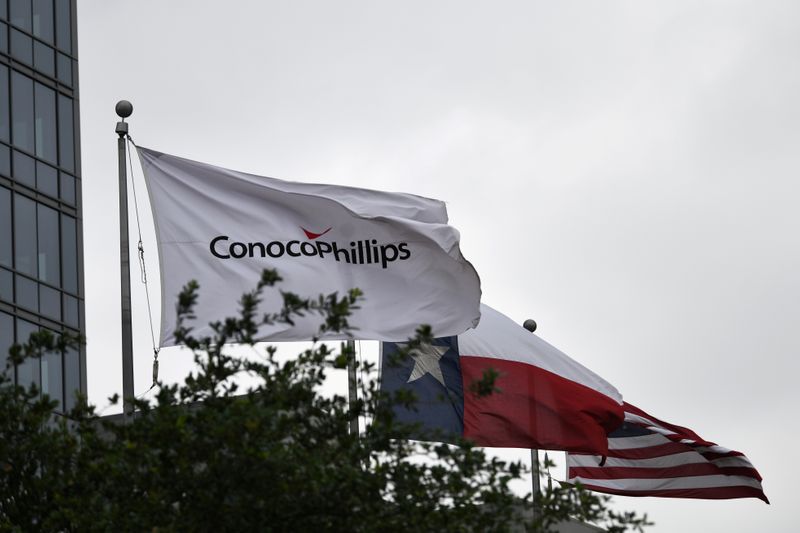 FILE PHOTO: Flags fly outside ConocoPhillips offices in Houston