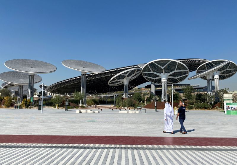 FILE PHOTO: People walk at the site of Dubai Expo