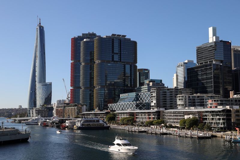 A boat navigates Darling Harbour past the Central Business District