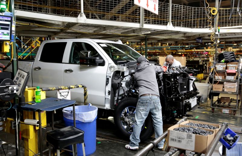 FILE PHOTO: GM assembly workers work on Chevrolet heavy-duty pickup
