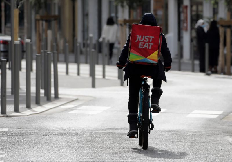 FILE PHOTO: A Just Eat delivery man rides his bicycle