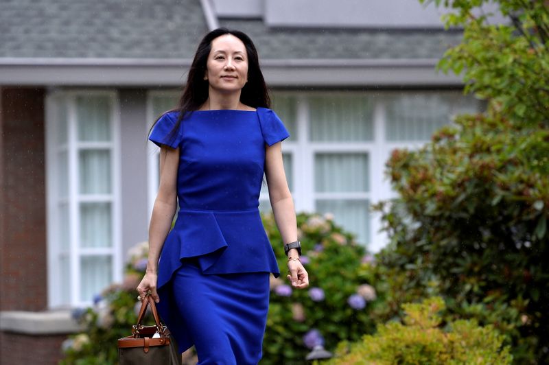 FILE PHOTO: Huawei CFO Meng Wanzhou leaves her home to