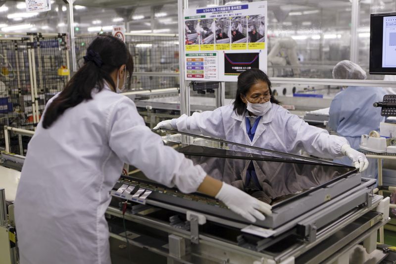 Women assemble an Aquos television at Sharp Corp’s Tochigi plant