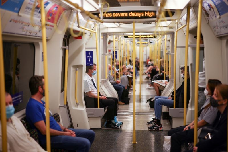 FILE PHOTO: People ride aboard a London Underground train, in