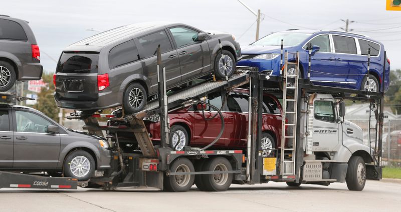 Car hauler transports newly assembled vehicles from the FCA Windsor