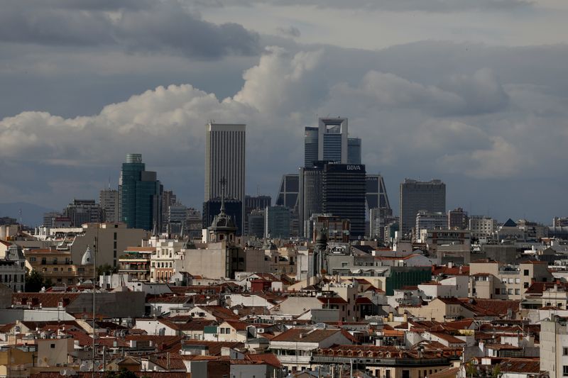 Clouds pass over business district buildings in Madrid