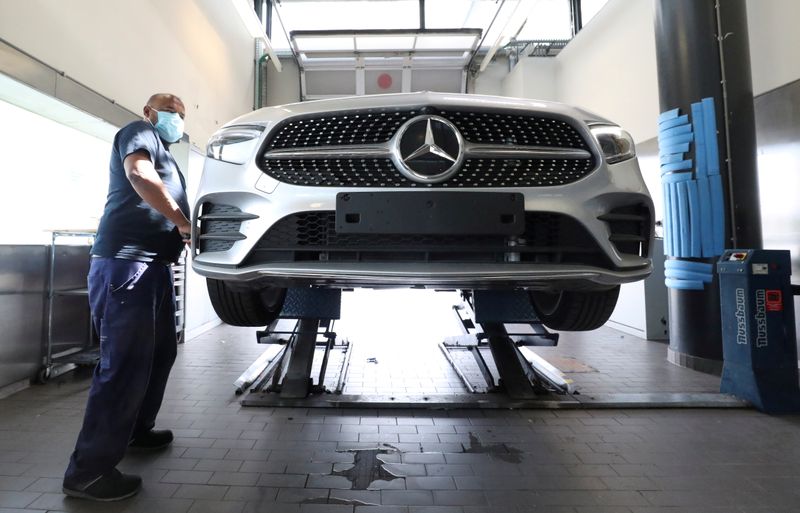 FILE PHOTO: An employee at a Mercedes-Benz dealership wearing a