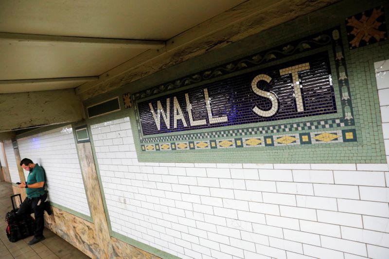 A person waits on the Wall Street subway platform in