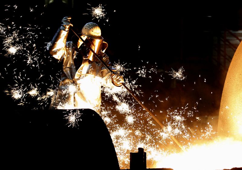A German steelmaker ThyssenKrupp worker controls a blast furnace in