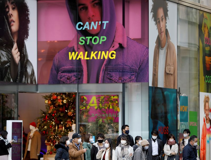 FILE PHOTO: People wear protective masks in a shopping district