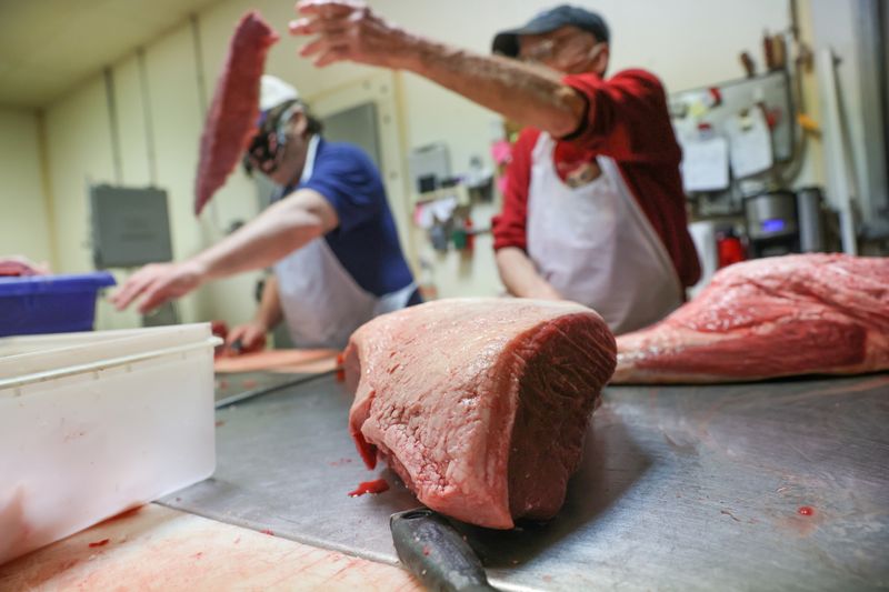 FILE PHOTO: Meat is trimmed to be ground at a