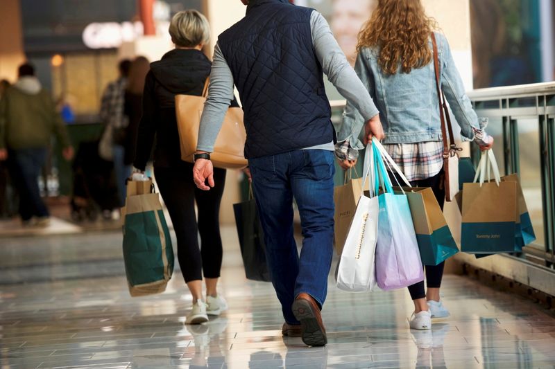 FILE PHOTO: Shoppers carry bags of purchased merchandise at the