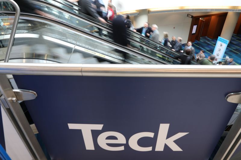 Visitors pass a sign of sponsor Teck Resources at the
