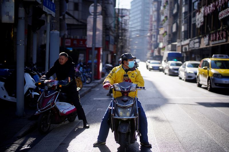 FILE PHOTO: A Meituan delivery worker wearing a face mask