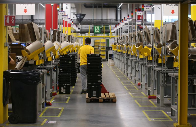 A worker moves boxes at a packaging area inside Amazon