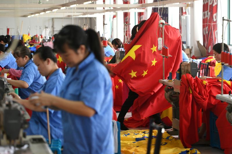 FILE PHOTO: Workers make Chinese flags at a factory ahead
