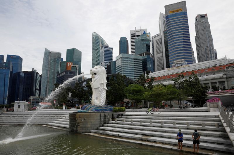 FILE PHOTO: Youth fish at a largely empty Merlion Park
