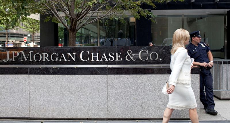FILE PHOTO: A woman walks past JPMorgan Chase & Co’s