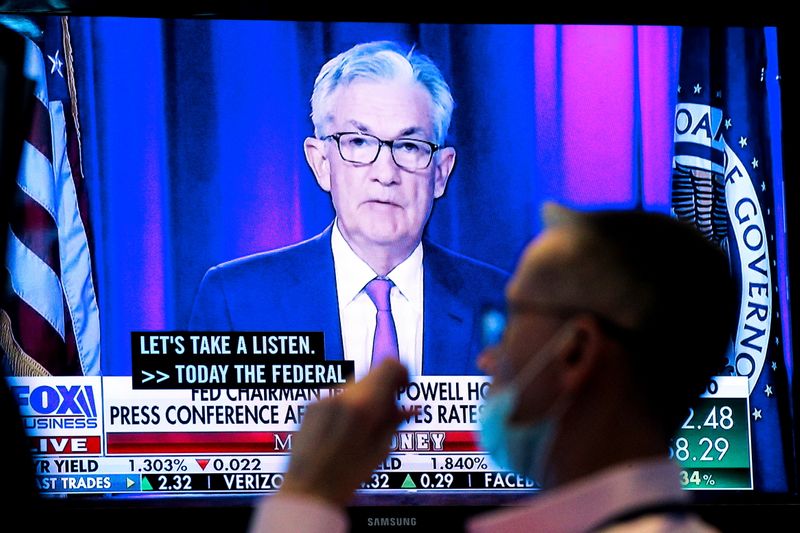 A screen displays a statement by Federal Reserve Chair Jerome