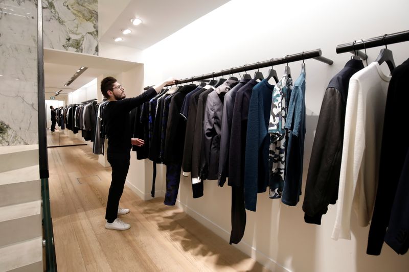 FILE PHOTO: An employee arranges a clothing display inside a