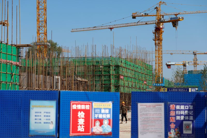 FILE PHOTO: A worker walks inside the construction site of