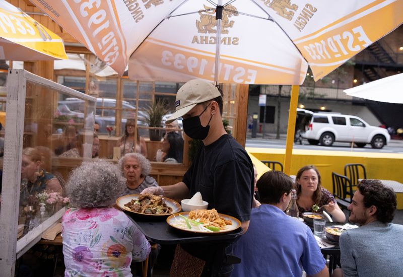 FILE PHOTO: People eat at a restaurant in Manhattan, New
