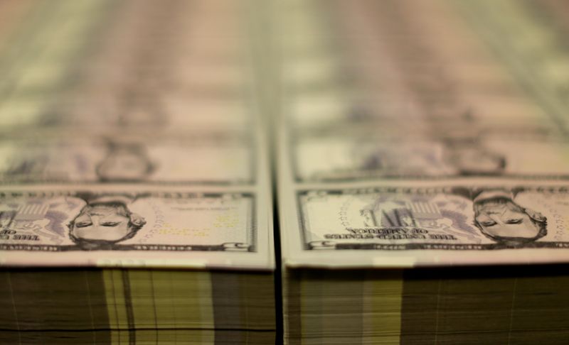 FILE PHOTO: Stacks of Lincoln five dollar bill are seen