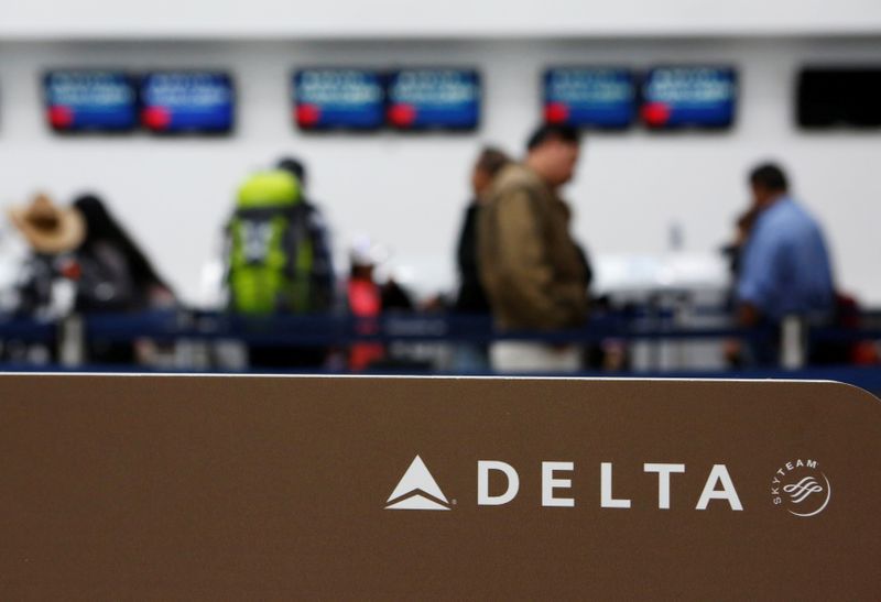 Passengers check in at a counter of Delta Air Lines