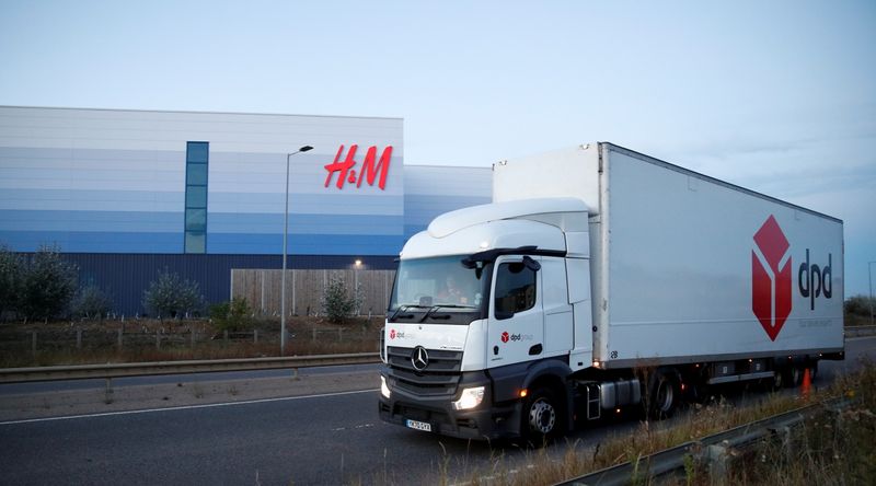 A DPD lorry drives past an H&M warehouse at Magna