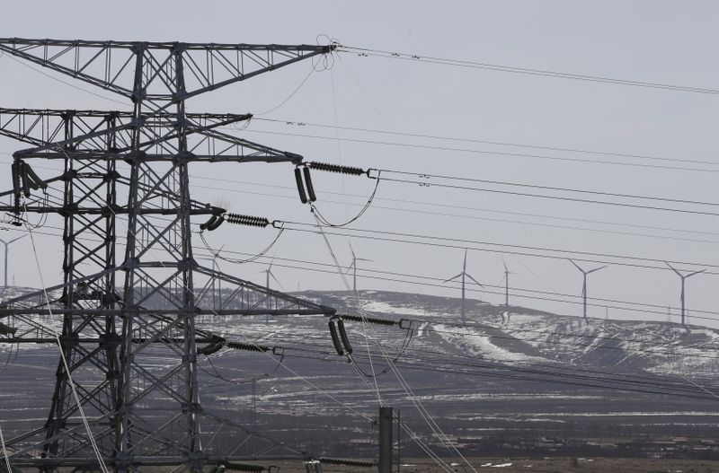 FILE PHOTO: FILE PHOTO: Power lines and wind turbines are