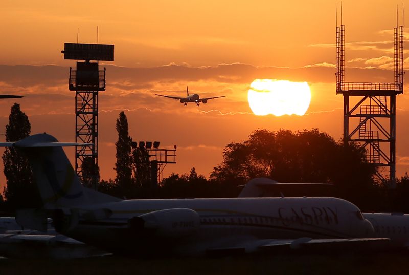 A plane descends before landing at an airport in Almaty