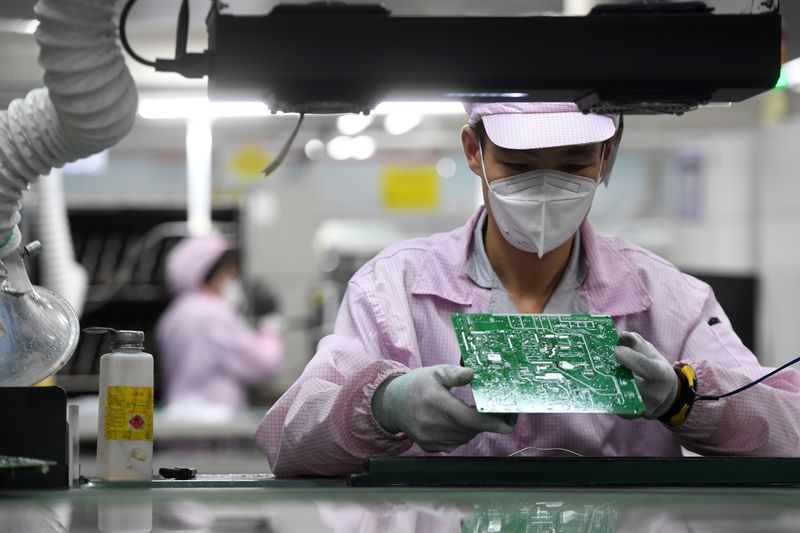 FILE PHOTO: Employee inspects a circuit board at a Gree