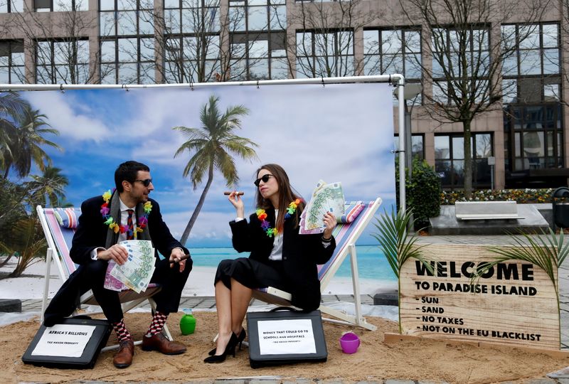 FILE PHOTO: Activists stage a protest on a mock tropical