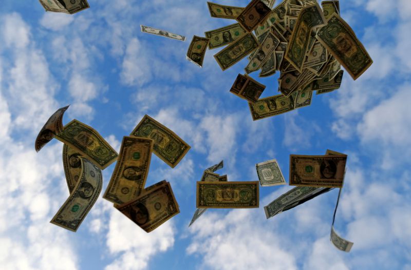FILE PHOTO: U.S. dollar bills blow in this photo illustration