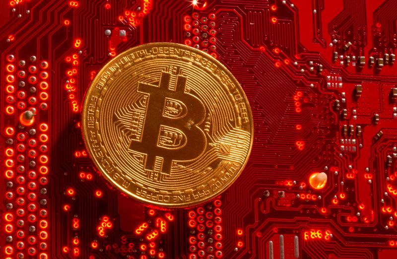 Representation of cryptocurrency Bitcoin is placed on PC motherboard in