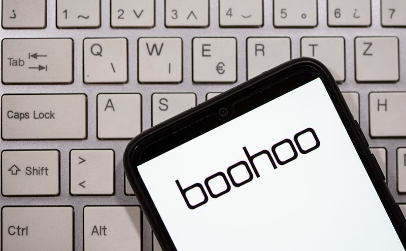 A smartphone with the Boohoo logo displayed is seen on