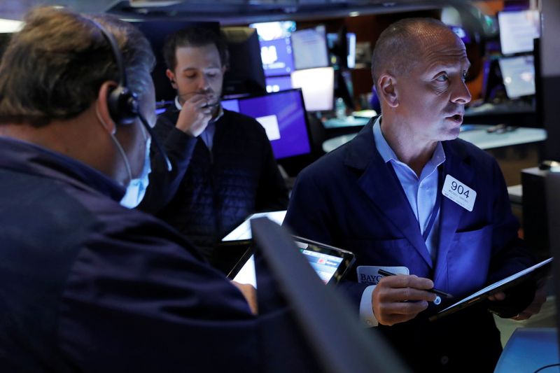 Traders work on the floor at the New York Stock