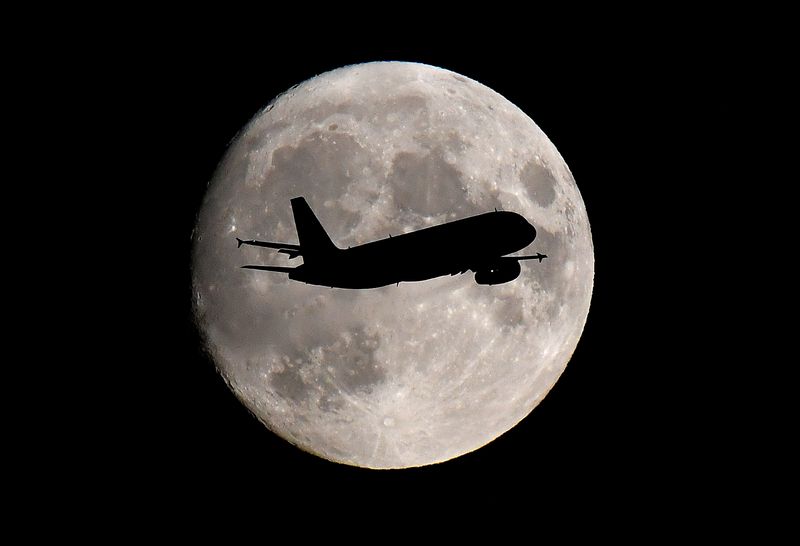 FILE PHOTO: A passenger plane passes in front of the