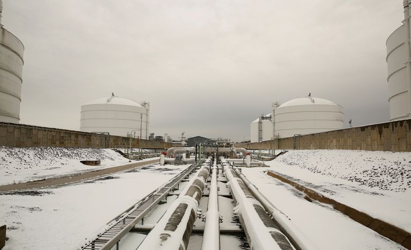 FILE PHOTO: Snow covered transfer lines leading to storage tanks