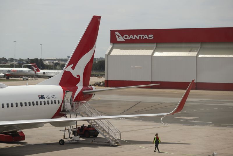 FILE PHOTO: A crew member walks from a Qantas plane