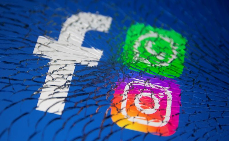 Facebook, Whatsapp and Instagram logos are displayed through broken glass