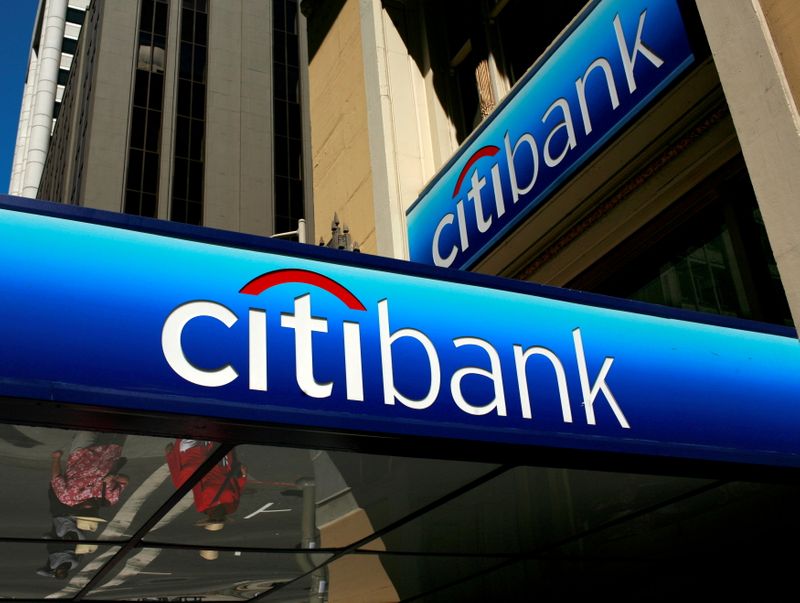 FILE PHOTO: FILE PHOTO: People walk beneath a Citibank branch