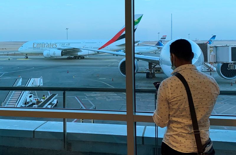 A passenger waits for his Emirates Airlines’ flight departure to