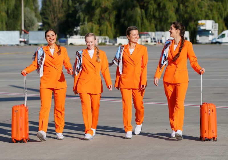 SkyUp Airlines flight attendants present a new uniform at an