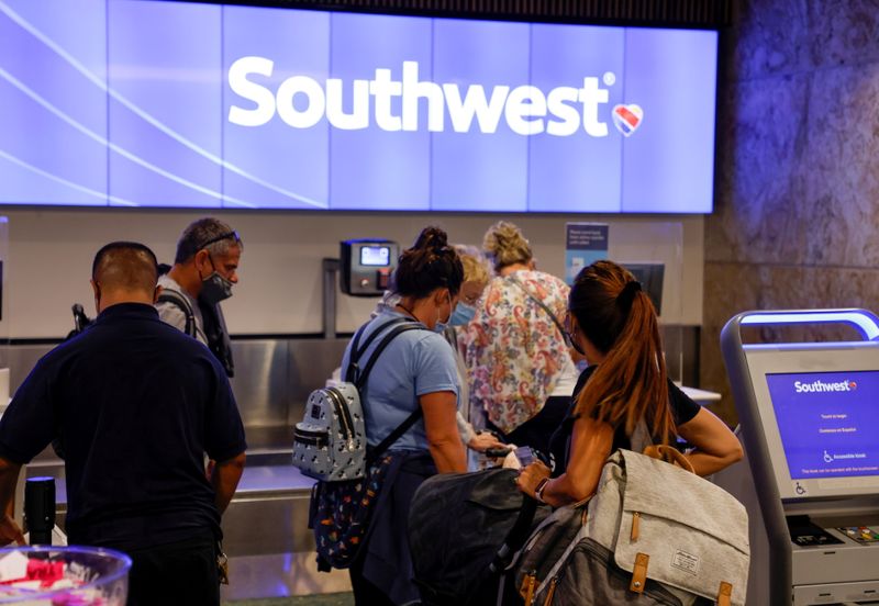 Passengers check in for a Southwest Airlines flight at Orlando