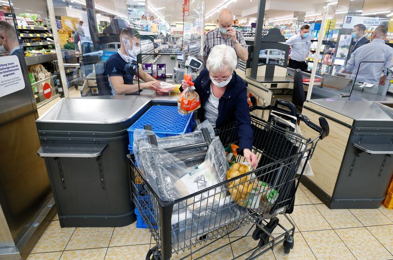 FILE PHOTO: Customers at the food discounter ALDI buy groceries,