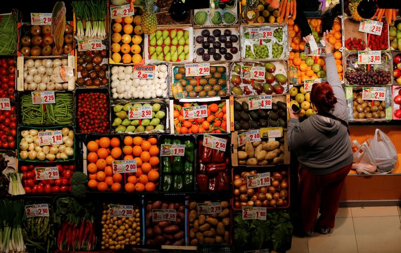 A woman makes purchases in a fruits and vegetables shop