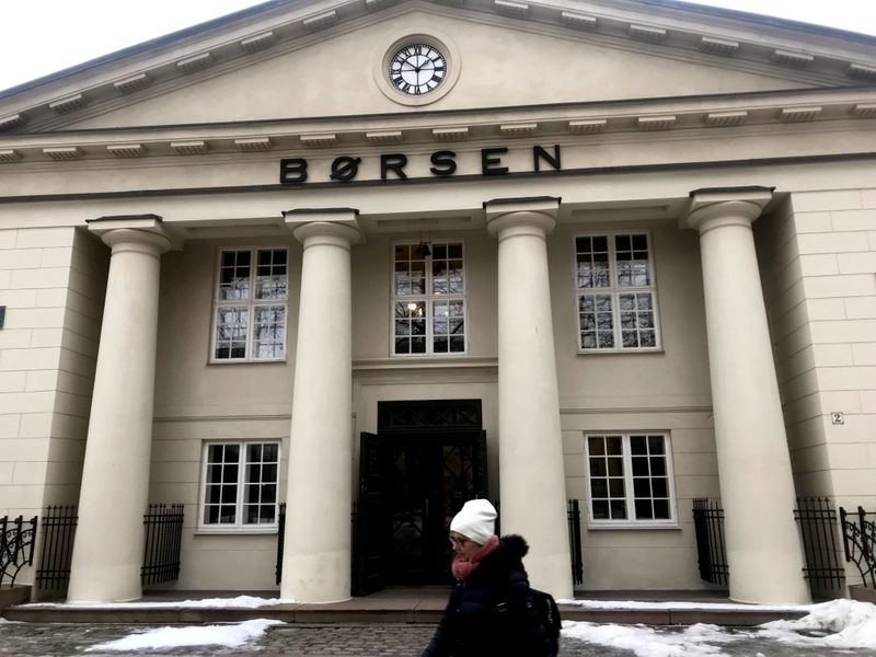 FILE PHOTO: A woman walks past the Oslo Stock Exchange