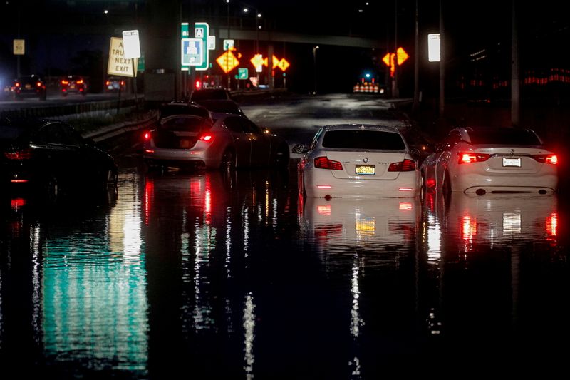 FILE PHOTO: Abandoned cars are left on a flooded highway