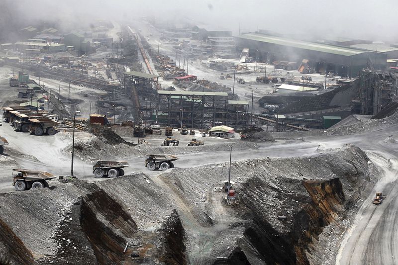 FILE PHOTO: FILE PHOTO: Trucks are parked at the open-pit